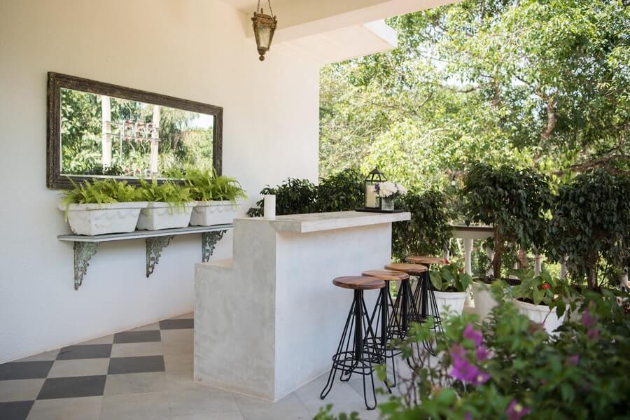 a garden bar with a mirror