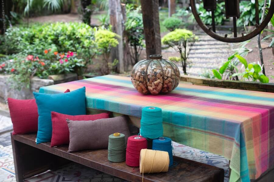 wooden outdoor dining table with colourful cloth