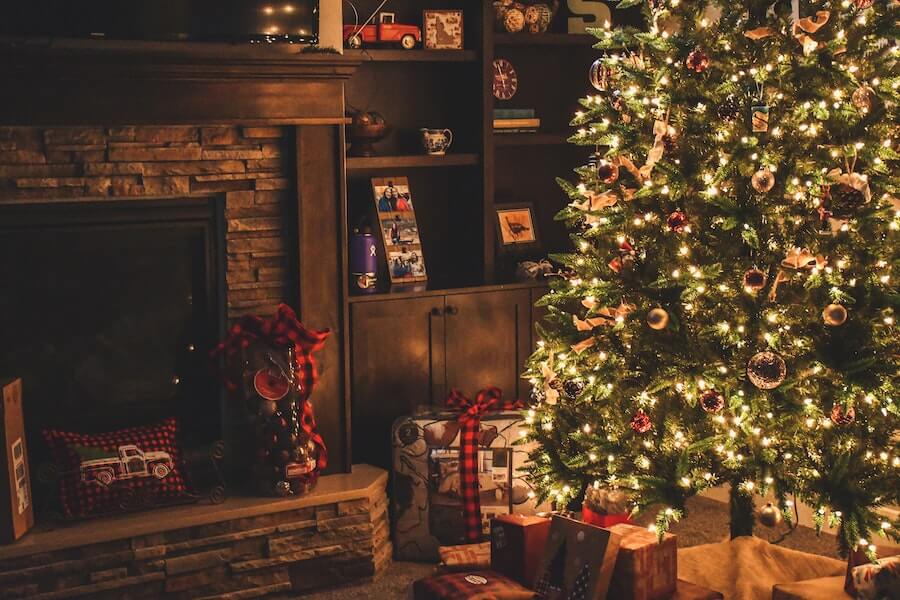 a festive living room with a Christmas tree with a hidden decoration for funny family Christmas traditions