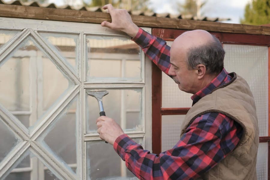 checking doors and windows on how to waterproof a shed
